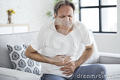 Senior man with stomach pain Stock Photo