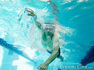 Senior man swimming laps, underwater view Stock Photo