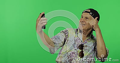 Senior man tourist make a photo on a smartphone. Selfie. Handsome old man Stock Photo