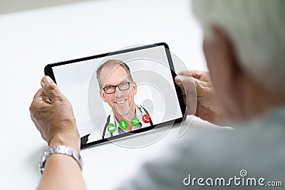 Senior Man In Videochat Or Videoconference With Doctor Stock Photo