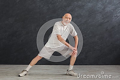 Senior man warmup stretching training indoors Stock Photo