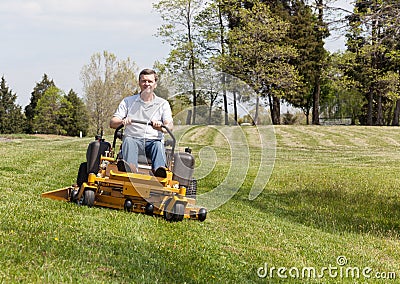 Senior man on zero turn lawn mower on turf Stock Photo