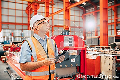 Senior Manager Engineer Supervisor Auditor working in metal factory looking production process Stock Photo