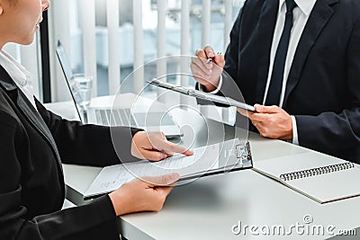 Senior manager HR reading a resume during a job interview employee young woman meeting Applicant and recruitment. Interview Stock Photo