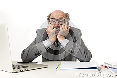 Mature business man with bald head on his 60s working stressed and frustrated at office computer laptop desk looking desperate Stock Photo