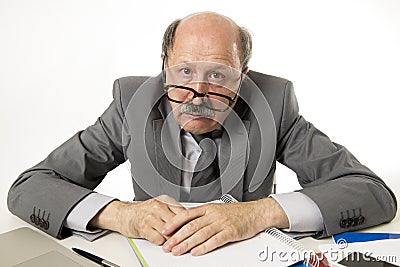 Senior mature busy business man with bald head on his 60s working stressed and frustrated at office computer laptop desk Stock Photo