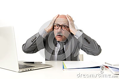 Senior mature busy business man with bald head on his 60s working stressed and frustrated at office computer laptop desk looking a Stock Photo