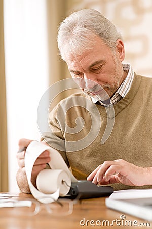 Senior mature man - home office with calculator Stock Photo