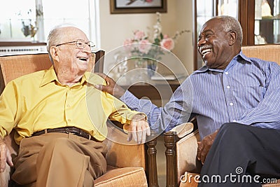 Senior men relaxing in armchairs Stock Photo