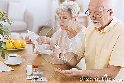 Senior man taking medication Stock Photo