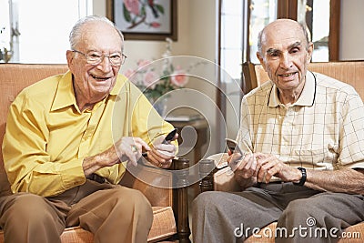 Senior men text messaging Stock Photo