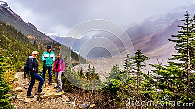 Seniors hiking on the moraines of the Victoria Glacier at Lake Louise, Banff National Park Stock Photo