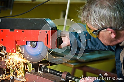 Metalworker cutting metal with rotary saw Stock Photo