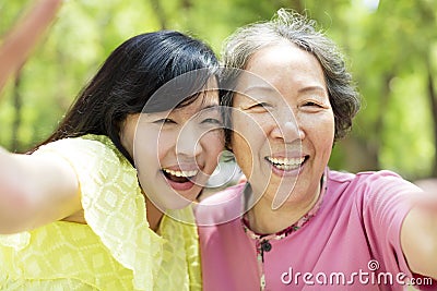 Senior mother and daughter taking selfie Stock Photo