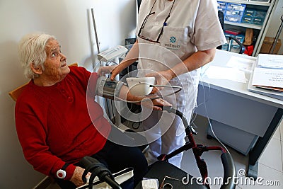 Senior with nurse on daily blood pressure control a nursing home in Mallorca Editorial Stock Photo