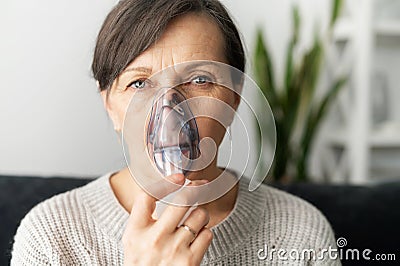 Senior older female cover face with an oxygen mask Stock Photo