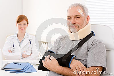 Senior patient broken arm in doctor office Stock Photo