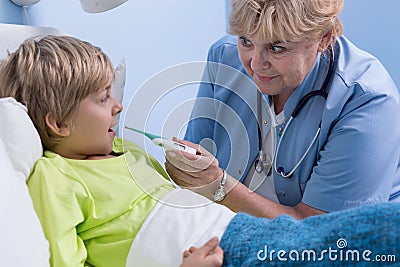 Senior pediatrician taking temperature Stock Photo