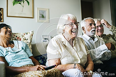 Senior people watching television together Stock Photo