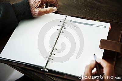 Senior person`s hand writing a journal Stock Photo