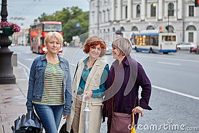 Senior pretty women walk on city street. Stock Photo