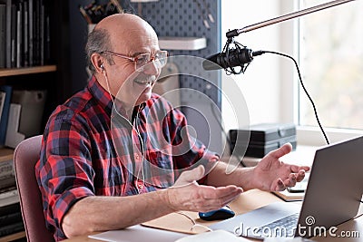 Smiling old elder grandfather talking to webcam on video chat sit at home Stock Photo