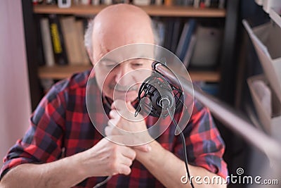 Smiling old elder grandfather talking to webcam on video chat sit at home Stock Photo