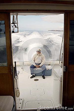 Senior Sailor Sitting On Yacht Stock Photo