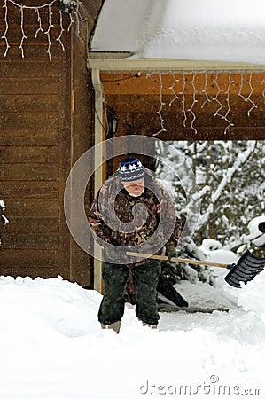 Senior shovelling snow Stock Photo