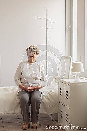 Senior sitting on the bed Stock Photo