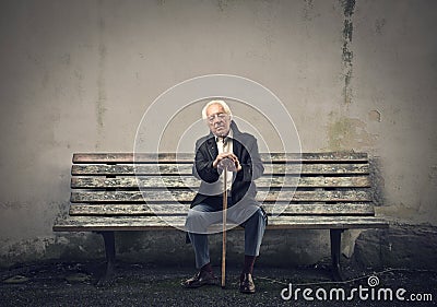 Senior sitting on a bench Stock Photo