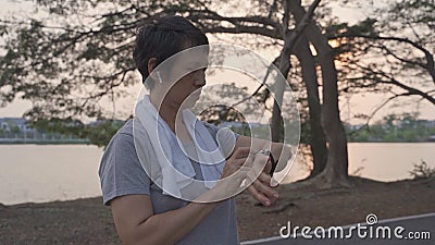 Senior sport femme utilisant l'application smart watch connectée au casque sans fil écouter de la musique. mature asiatique femell clips vidéos Senior sport femme utilisant l'application smart watch connectée au casque sans fil écouter de la musique. mature asiatique femell clips vidéos