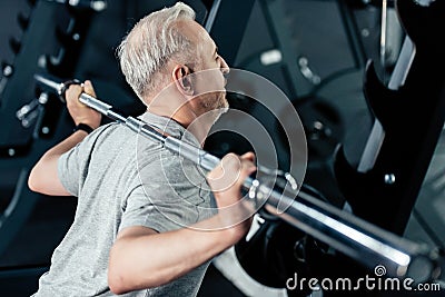 senior sportsman training with barbell Stock Photo