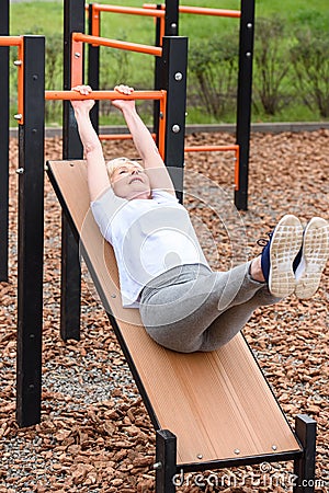 senior sportswoman doing abs Stock Photo