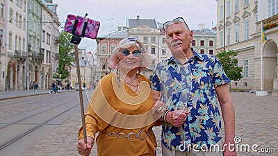 Senior stylish blogger tourists man woman taking selfie photo, making video call on mobile phone Stock Photo