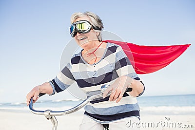 Senior superwoman on a bike Stock Photo