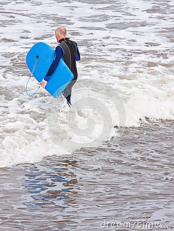 Senior in the surf Editorial Stock Photo