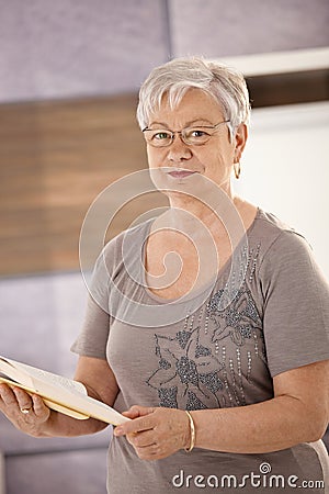 Senior teacher holding textbook Stock Photo