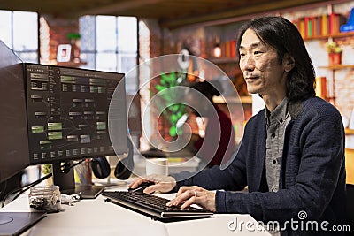 Senior technician coding advanced AI algorithm in startup office Stock Photo