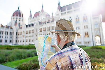 Senior tourist man watching map at Parliament, Budapest, Hungary Stock Photo