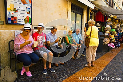 Senior tourists resting on chairs and enjoying a cold ice cream, Bardolino Italy Editorial Stock Photo
