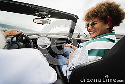 Senior trendy couple inside a convertible car on holiday time - Focus on woman face Stock Photo