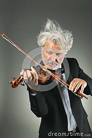 Senior violinist with upset white hairs Stock Photo