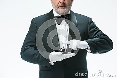 Senior waiter holding bell Stock Photo