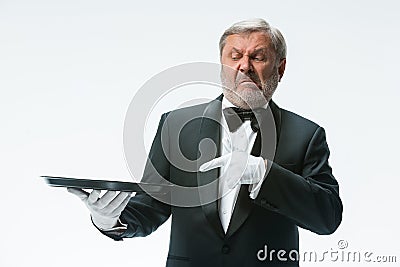 Senior waiter holding tray Stock Photo