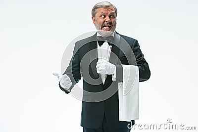 Senior waiter holding white towel Stock Photo
