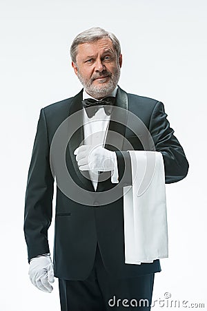 Senior waiter holding white towel Stock Photo