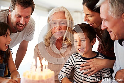 Senior white woman celebrating her birthday with family, blowing out candles on her cake, close up Stock Photo