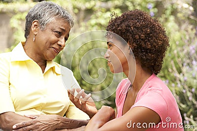 Senior Woman And Adult Daughter Chatting Stock Photo