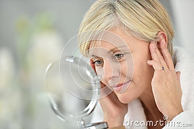 Senior woman applying anti-aging cream Stock Photo